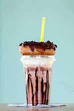 Chocolate extreme milkshakein donuts a plastic cup