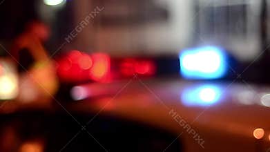 Traffic police officers works on the street. Policeman at work. Police emergency lights flash at night. Car accident. Crime scene.