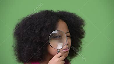 Young cute African girl with Afro hair using magnifying glass