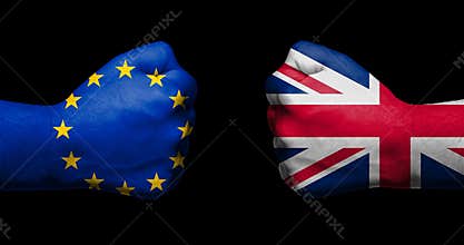 Flag of European Union and Great Britain painted on two clenched fists facing each other on black background/Brexit concept