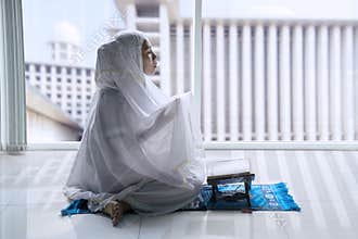Religious Muslim woman praying to the Allah