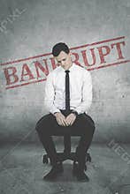 Desperate male entrepreneur with word of bankrupt