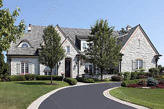 Luxury stone home with circular driveway