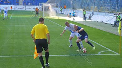 Soccer game, player is running with the ball.