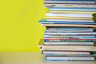 Many childrens books are stacked on top of each other. Green ba