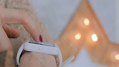 Woman using smart watch at home