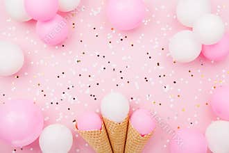 Party or birthday background with pastel balloons and confetti top view. Flat lay style.