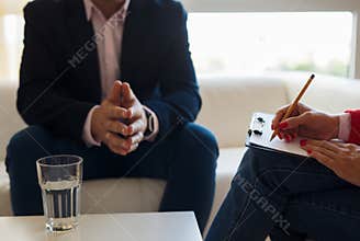 Young man talking with therapist