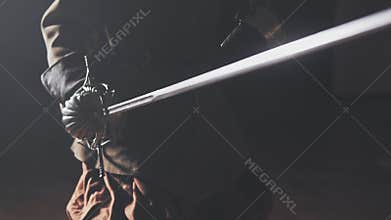 Medieval warrior with sword indoors in slow motion