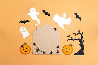Flat lay Halloween background with cartoon house, spiders,pumpkins and ghosts.
