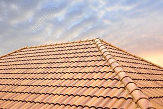 Roof tiles and sky sunlight.Roofing Contractors concept Installing House roof.