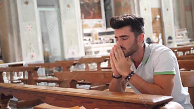 Young man praying in church