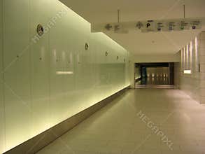 Underground corridor, signs and back-lighted walls