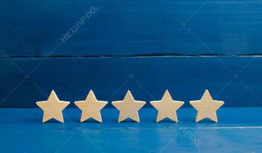 Five stars on a blue background. The concept of rating and evaluation. The rating of the hotel, restaurant, mobile application. Qu
