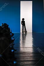 Silhouette of model on catwalk