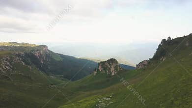 Group of tourist people hiking in green mountain aerial landscape