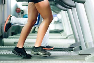 People on treadmill in gym running