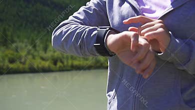 Slow motion. Health sport young woman run and look wear smart watch device