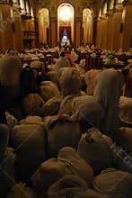 Pilgrims bowing during mass service