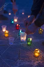 A man lights a candle. Day of Remembrance for the Bereaved