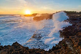 Storming Sea Waves Crashing on the Shore at Sunset