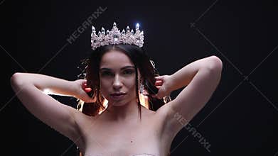 Female model in the crown posing in the studio jewelry