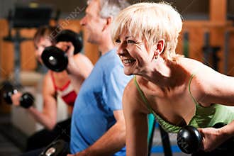 Three senior people in gym