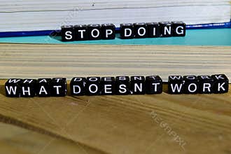 Stop doing what doesn`t work on wooden blocks. Motivation and inspiration concept.