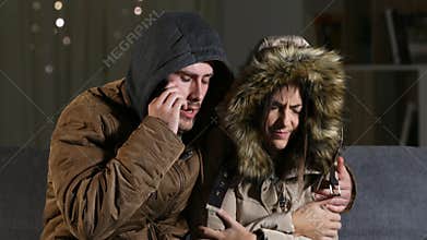 Couple calling insurance about heater damage