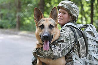 Man in military uniform with German shepherd dog
