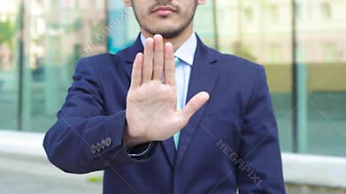 Crop businessman gesturing stop