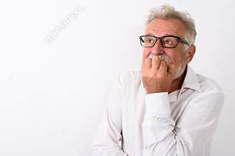 Close up of senior bearded man looking scared while thinking and