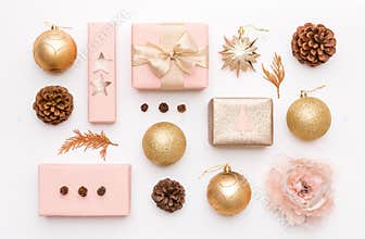 Pink and gold christmas gifts isolated on white background. Wrapped xmas boxes, christmas ornaments, baubles and pine cones.