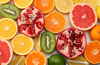 healthy food. mix sliced lemon, green lime, orange, mandarin, kiwi fruit and grapefruit isolated on white background. top view