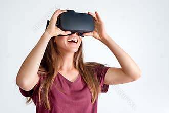 Smiling positive woman wearing virtual reality goggles headset, vr box. Connection, technology, new generation, progress concept.