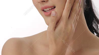 Close up portrait of beautiful young asian woman touching face and healthy skin in slow motion skincare concept.