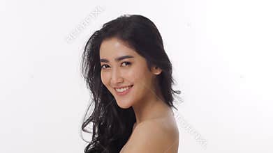 Attractive Asian woman tossing her long hair