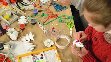 Children making decoration for holidays, crafts and toys, christmas tree and other.