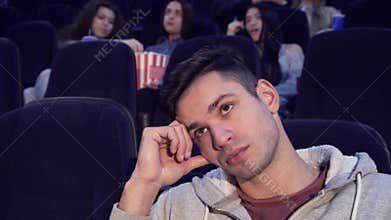 Man gets bored at the movie theater