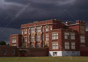 Red Brick School With Dark Storm Clouds