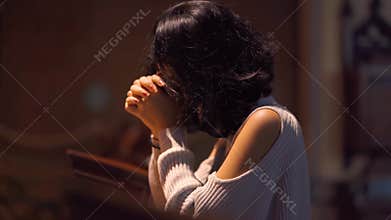 Christian woman praying to GOD in the church