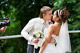 Kiss the bride and groom at wedding walk