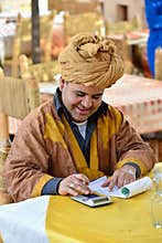 Arabian cafe owner calculating his bills