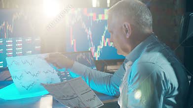 A stockbroker is looking at the report with stock information. Financial, investment, business concept.