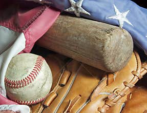 Old baseball bat, mitt, ball and flag.