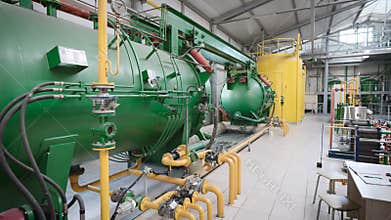 A workshop with a complex chemical process. Tanks and pipelines.