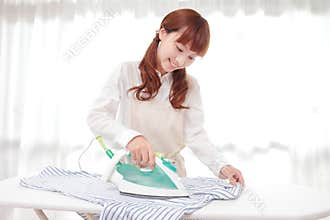Young Asian women to the ironing