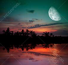 The ocean, sunset and moon