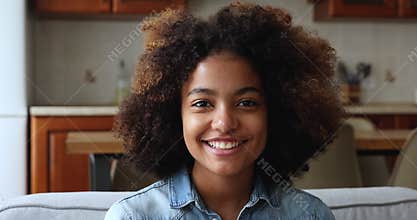 Pretty African American female teenager looking at camera with smile