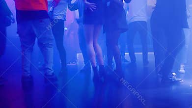 Blurry: Many beautiful female legs are partying and clubbing at a nightclub